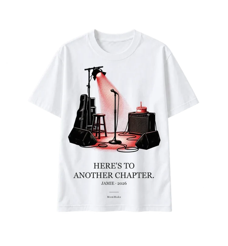 White Heavyweight Tee digital mockup, Another chapter, words: HERE'S TO / ANOTHER CHAPTER., name line: JAMIE · 2026