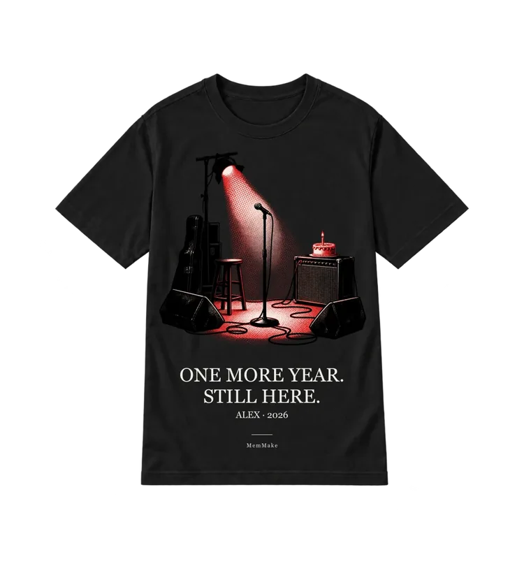 Black Everyday Tee digital mockup, Another year, words: ONE MORE YEAR. / STILL HERE., name line: ALEX · 2026